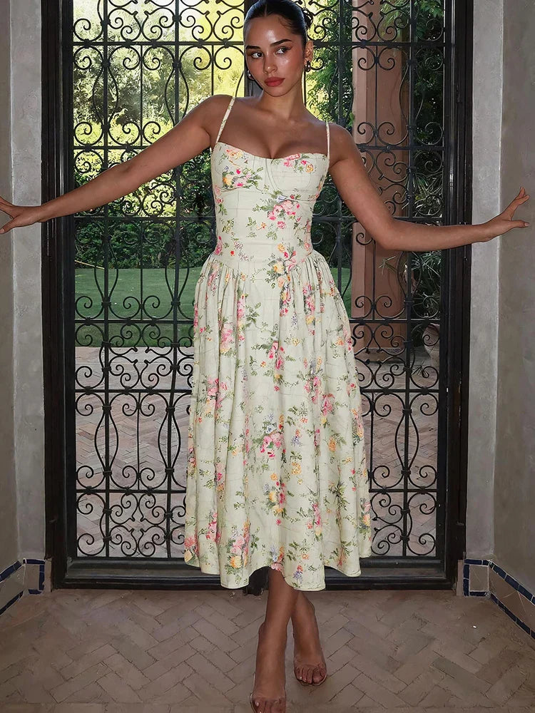 Full length view of floral strap midi wedding guest dress showing mid-calf length and romantic flowing skirt