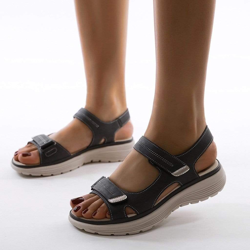Poppy wearing orthopaedic walking sandals with arch support featuring dual adjustable straps and cushioned soles for all-day comfort