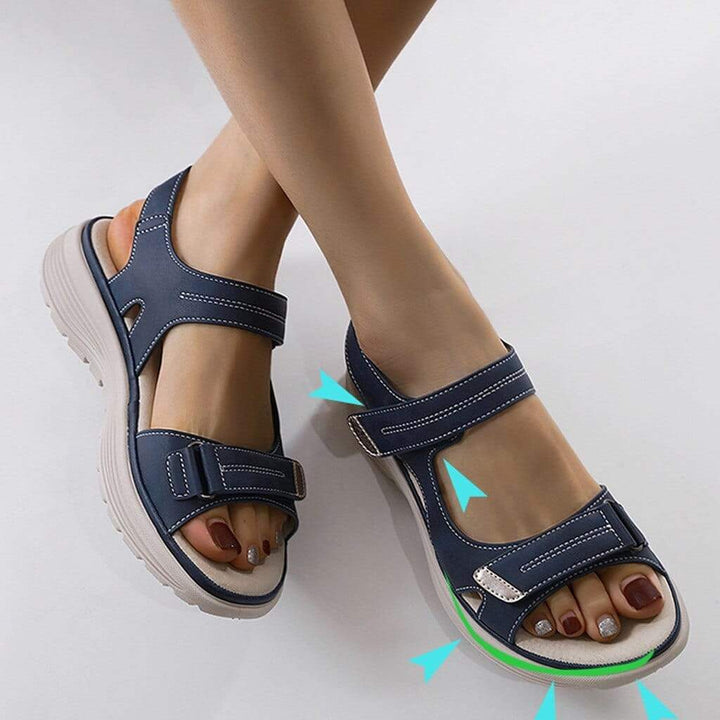 Close-up view of orthopaedic walking sandals with arch support showing hook-and-loop closures and shock-absorbing sole design