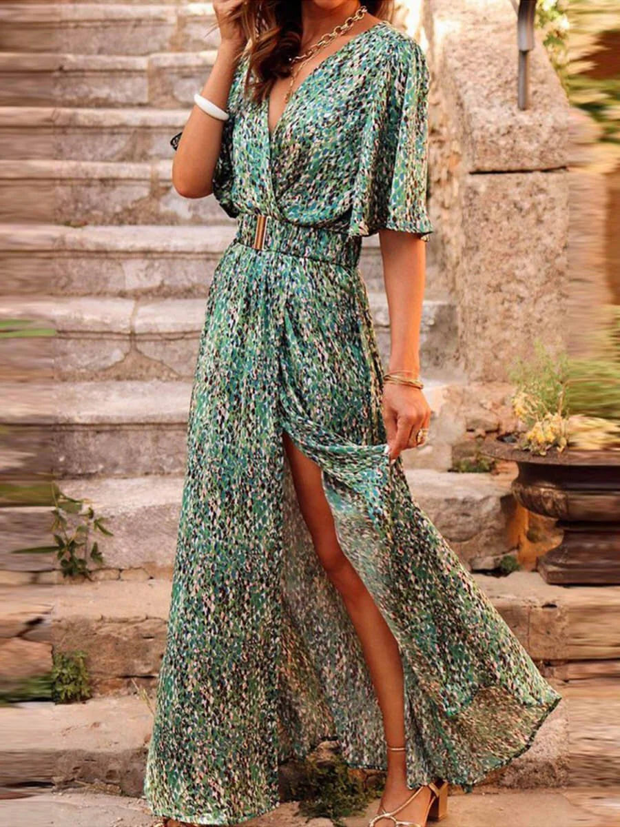V-neck maxi dress with green floral print and split hem, shown on model in outdoor setting