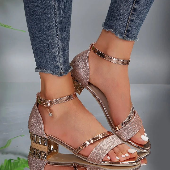 Women's glitter heels with ankle strap worn with cropped denim jeans for occasion styling