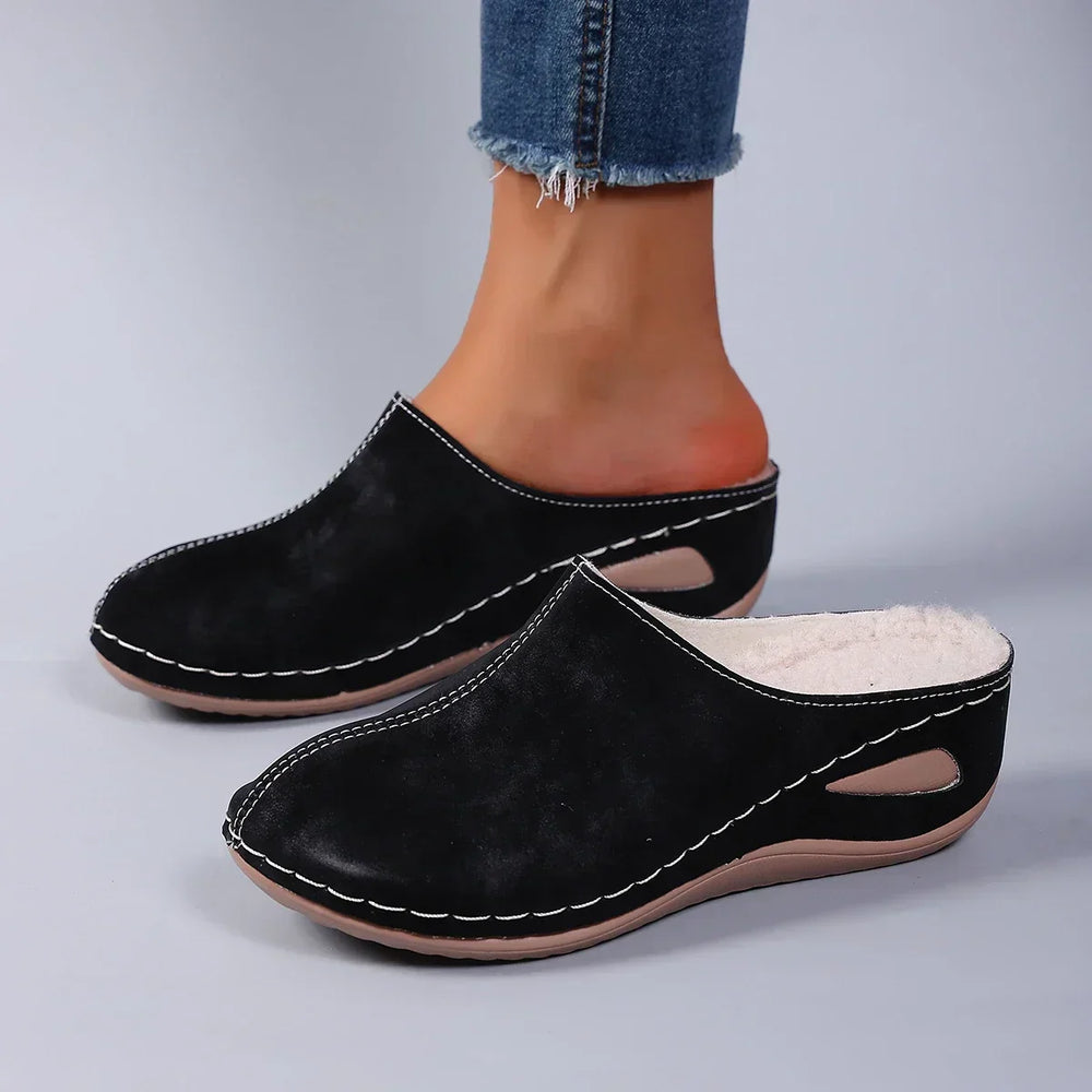 Close-up view of blue orthopaedic slippers showing soft suede-effect upper and warm fleece interior lining