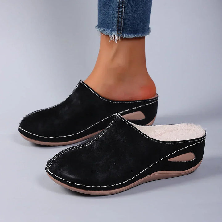 Close-up view of blue orthopaedic slippers showing soft suede-effect upper and warm fleece interior lining