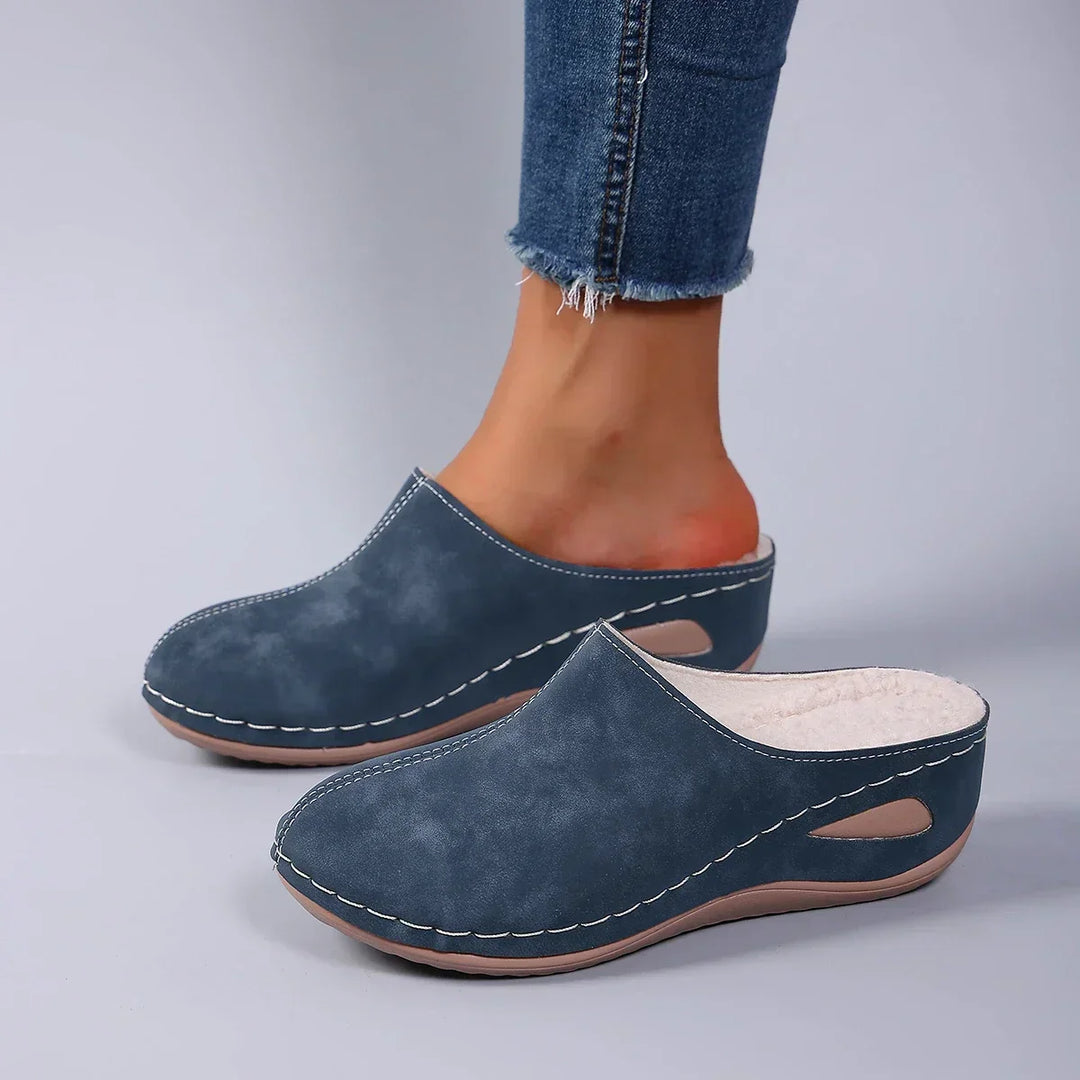 Overhead view of orthopaedic cozy slippers displaying rounded toe shape and supportive arch construction