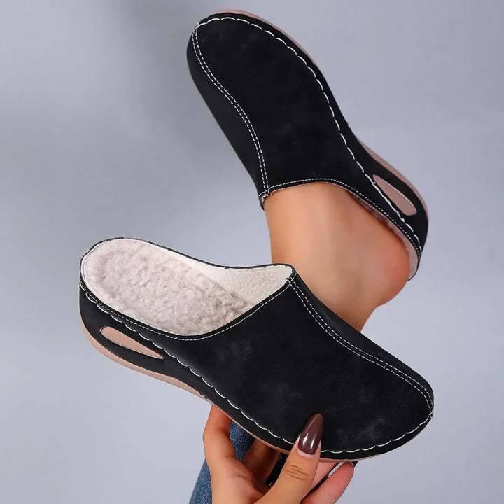 Women's indoor slippers with contrast stitching detail and cushioned sole for all-day comfort at home