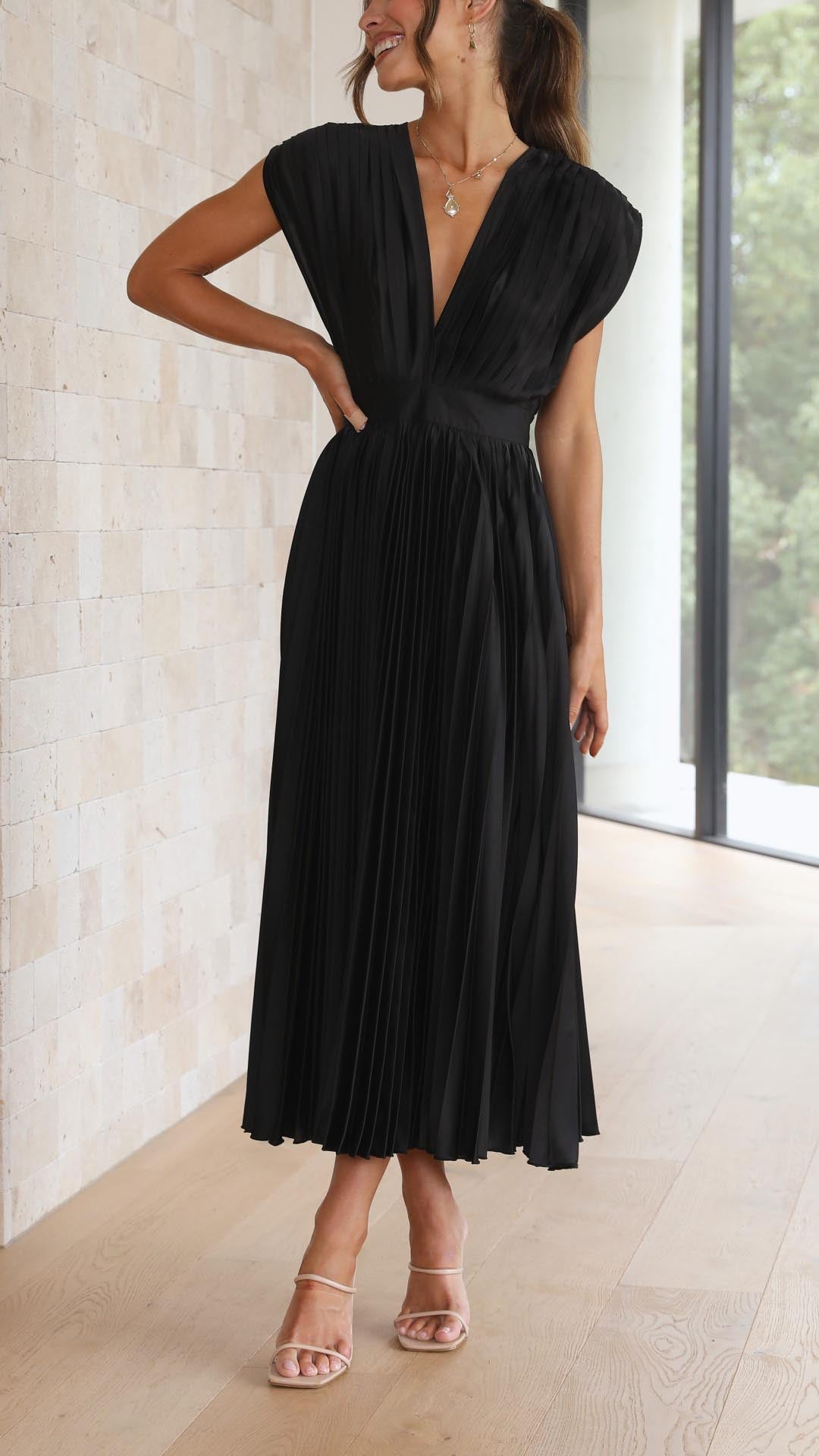 Close-up of cap sleeve detail on pleated V-neck wedding guest dress