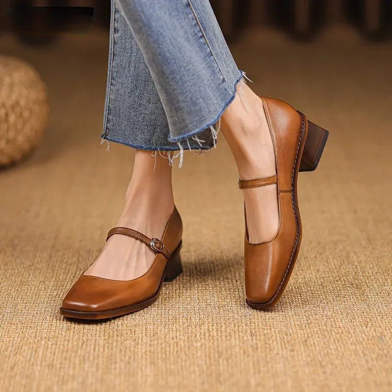 Women's strap block heel shoes in tan brown with adjustable buckle strap and structured block heel on model