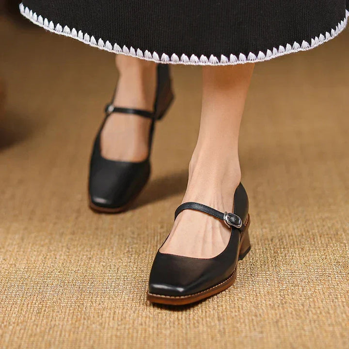 Rear view of women's strap block heel shoes highlighting structured heel and clean lines