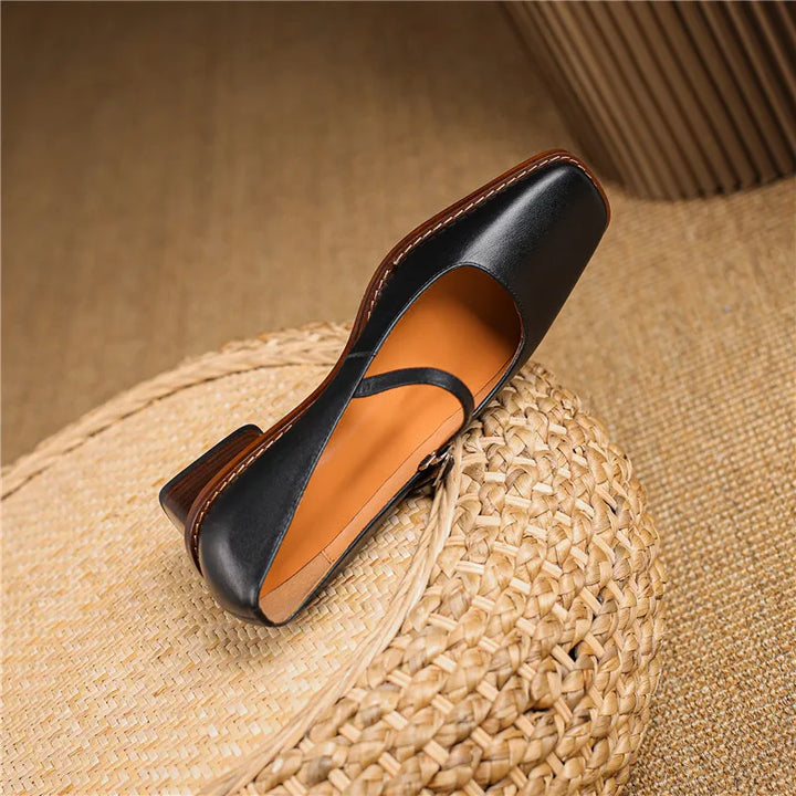 Women's strap block heel shoes styled with tailored trousers for polished daytime look