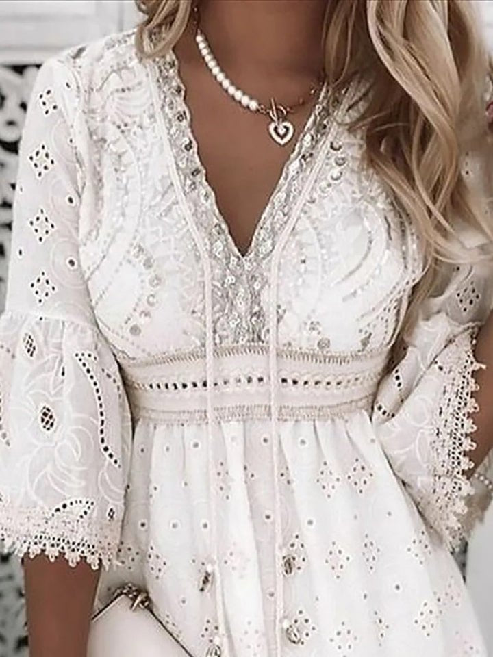 Full-length view of the above-the-knee mini dress showcasing the romantic lace detailing and flattering A-line shape