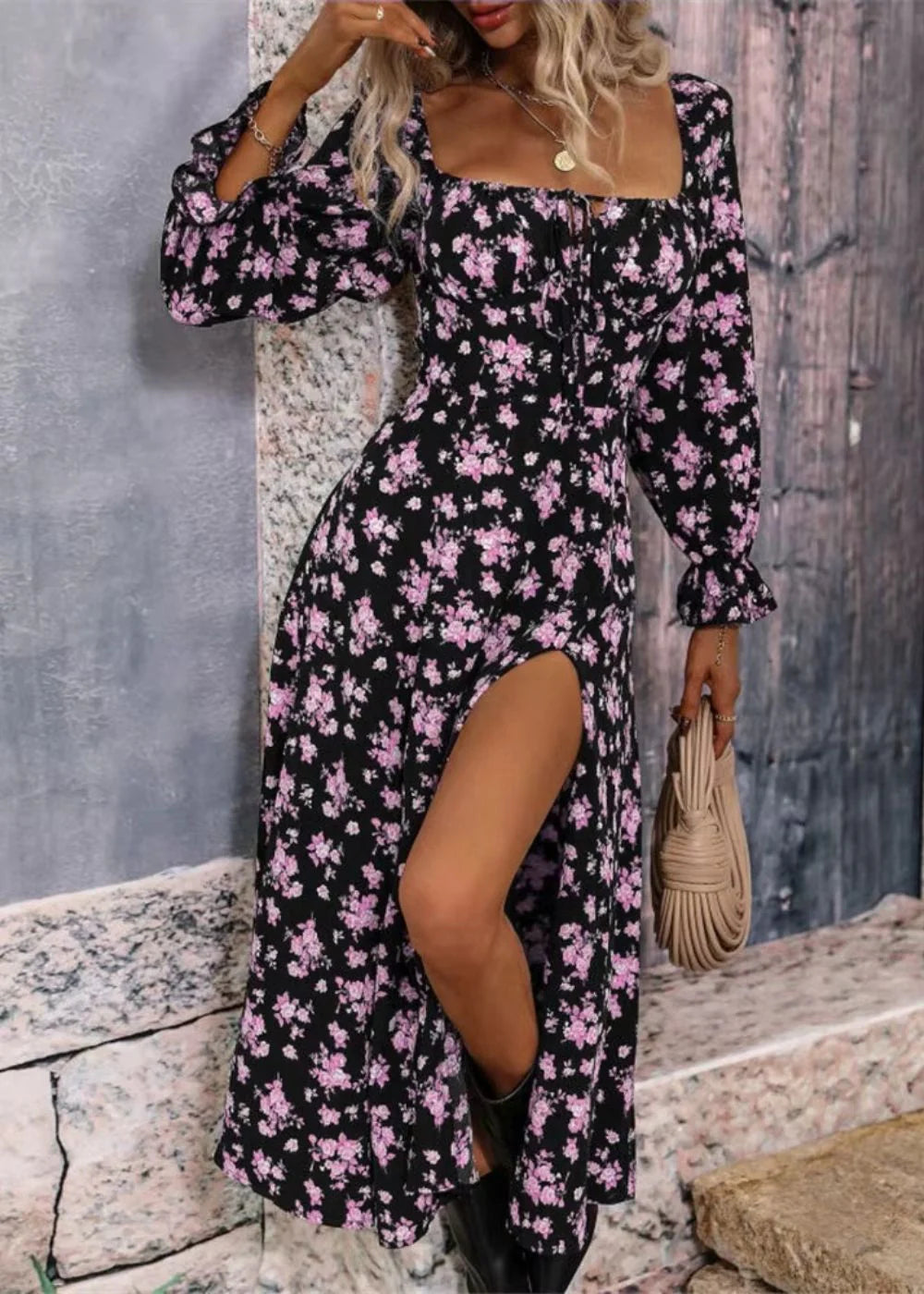 Side angle of midi-length floral dress with empire waist and puff sleeves