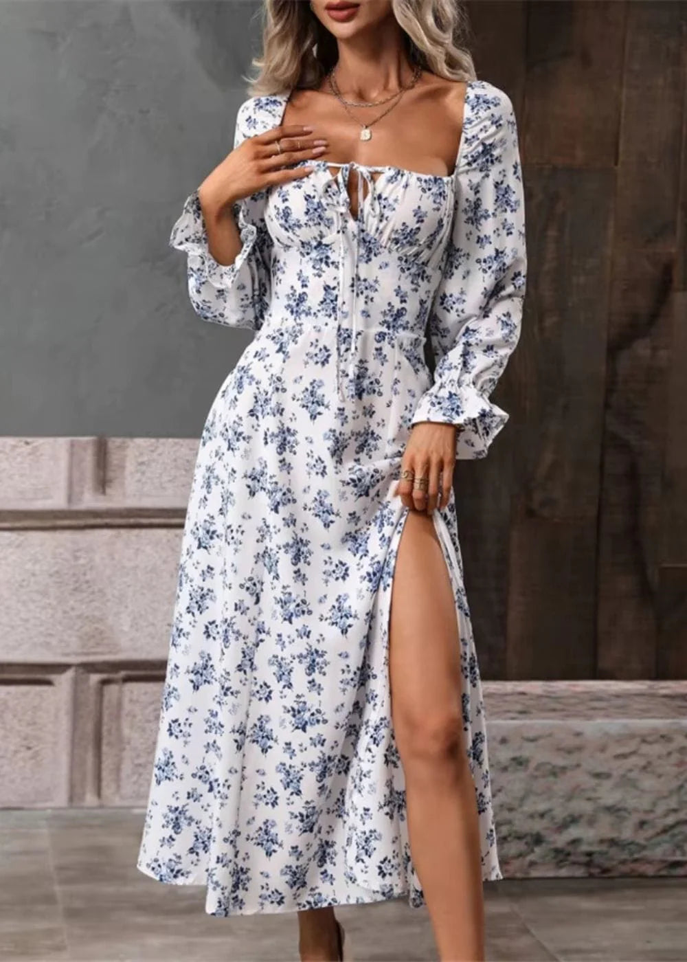Side view of midi-length floral dress with elasticated puff sleeves and flowing skirt