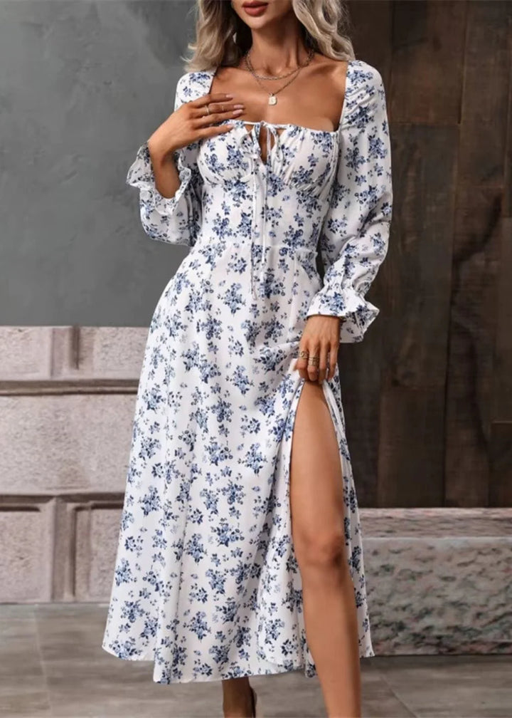 Side view of midi-length floral dress with elasticated puff sleeves and flowing skirt