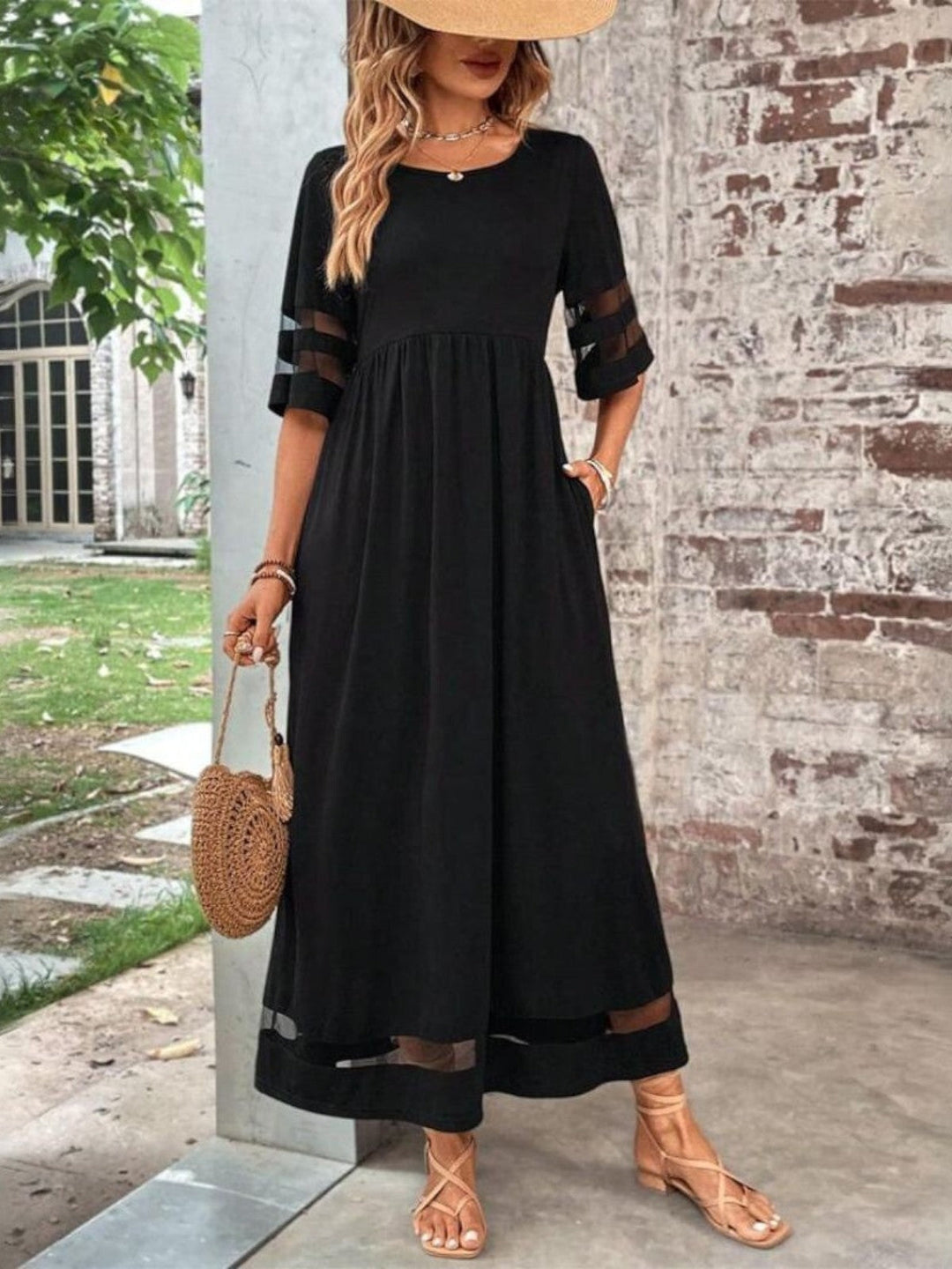 Saskia wearing a Women's Tummy Flattering Summer Dress in black with mesh sleeve detail and flowing maxi length