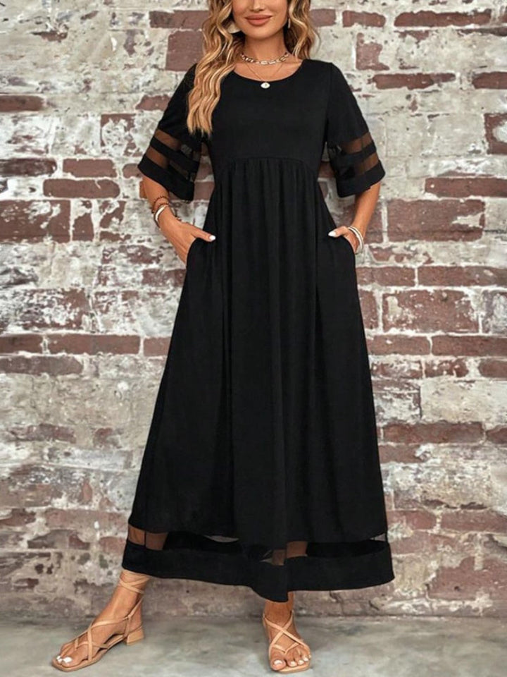 Detail of the round neckline and horizontal mesh stripes on the elbow-length sleeves