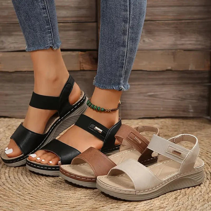 Women's summer sandals in brown featuring low wedge sole and supportive arch design
