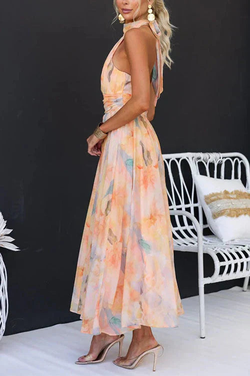 Close-up of watercolour print detail on Women's Halter Watercolour Maxi Dress in peach and blue tones