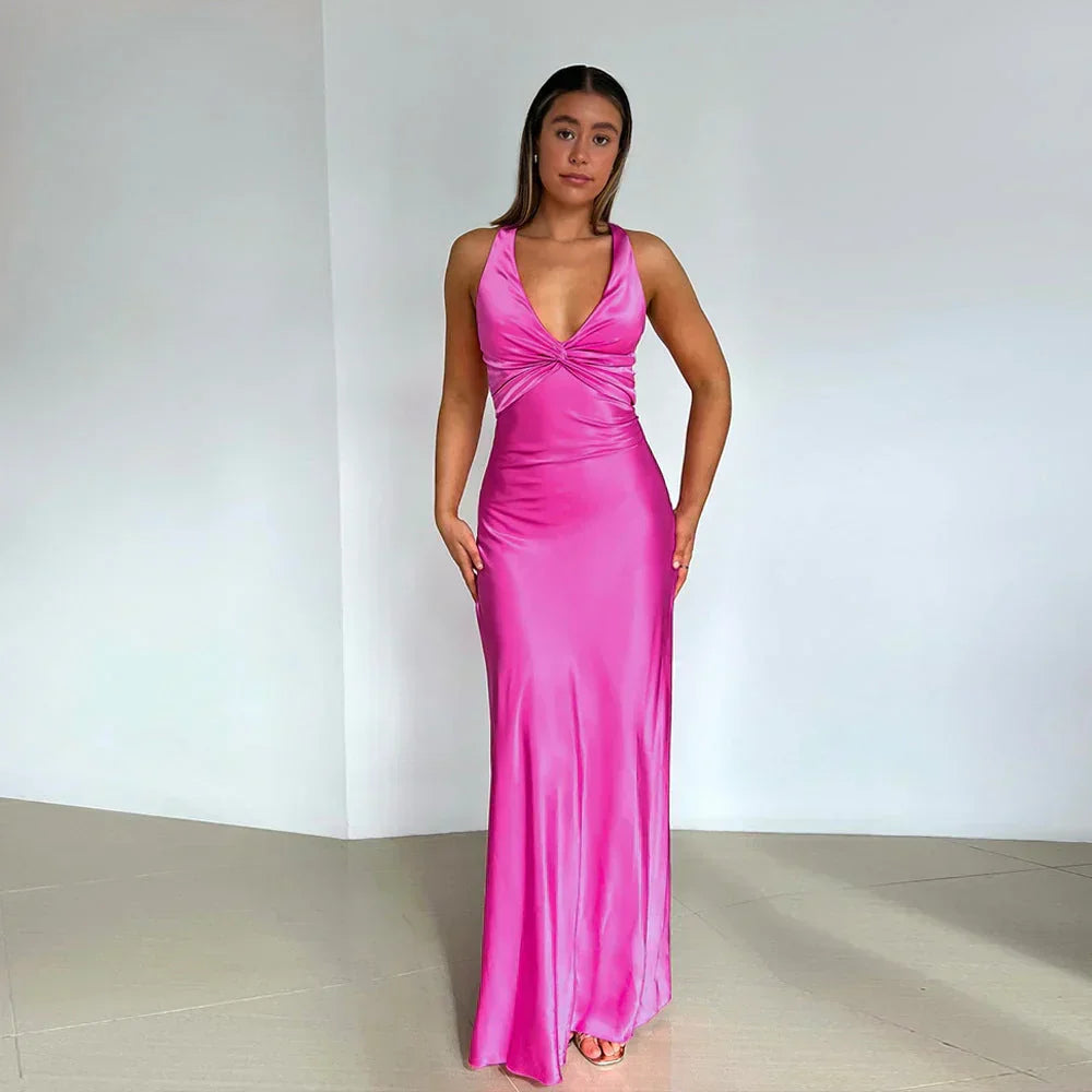 Front view of sleeveless crossover neckline wedding guest dress showing twisted bust detail and flowing skirt