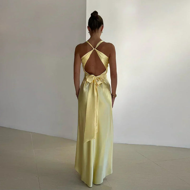Back view of formal maxi dress showing sleeveless cut and concealed zip closure