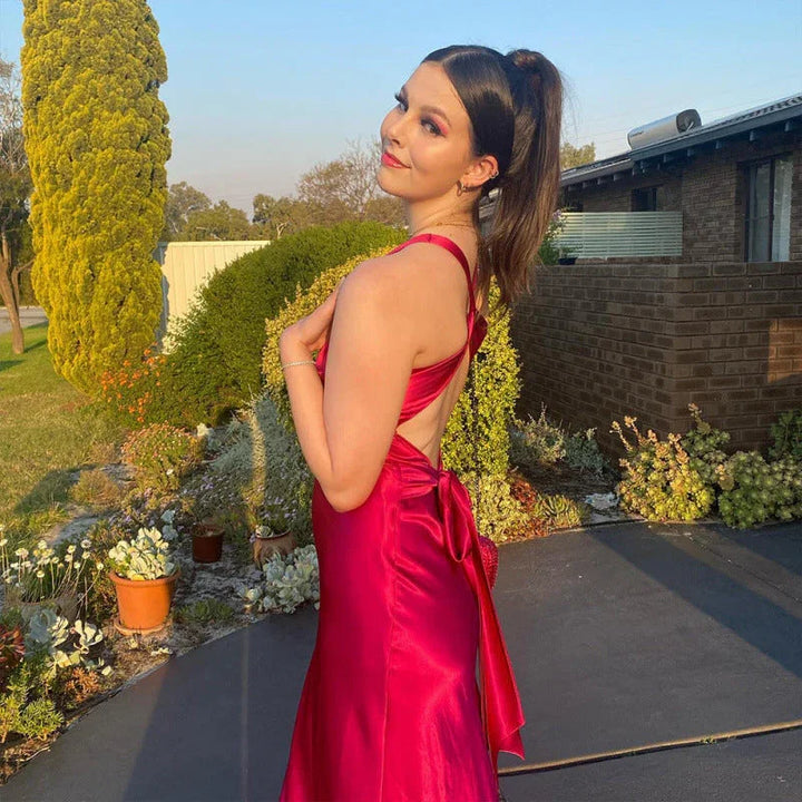 Woman posing in yellow maxi dress with crossover neckline suitable for wedding guest attire