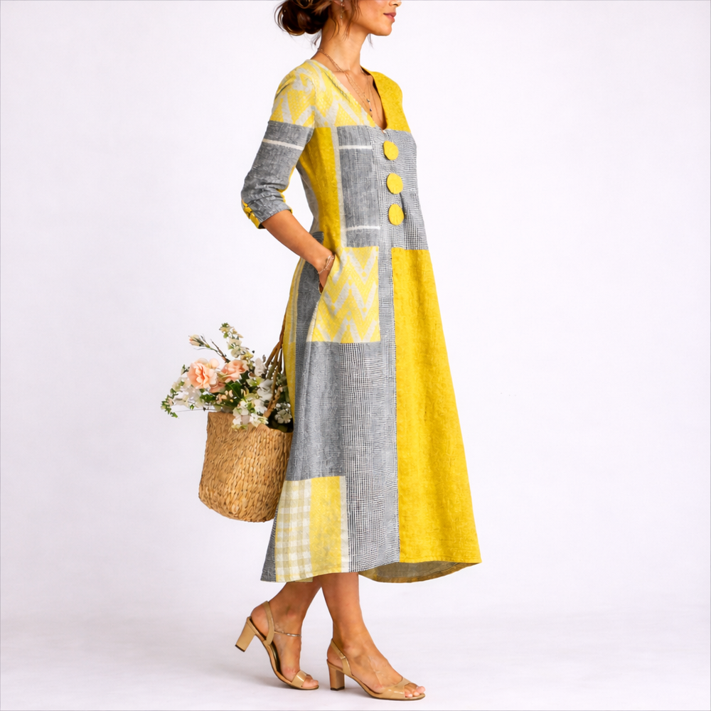 Close-up view of patchwork midi dress showing textured fabric panels and decorative button detailing