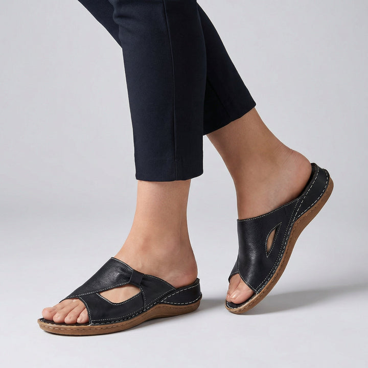 Tilly wearing Orthopedic Slide Sandals Open-Toe Leather Comfort with contrast stitching and cutout detail on low wedge sole