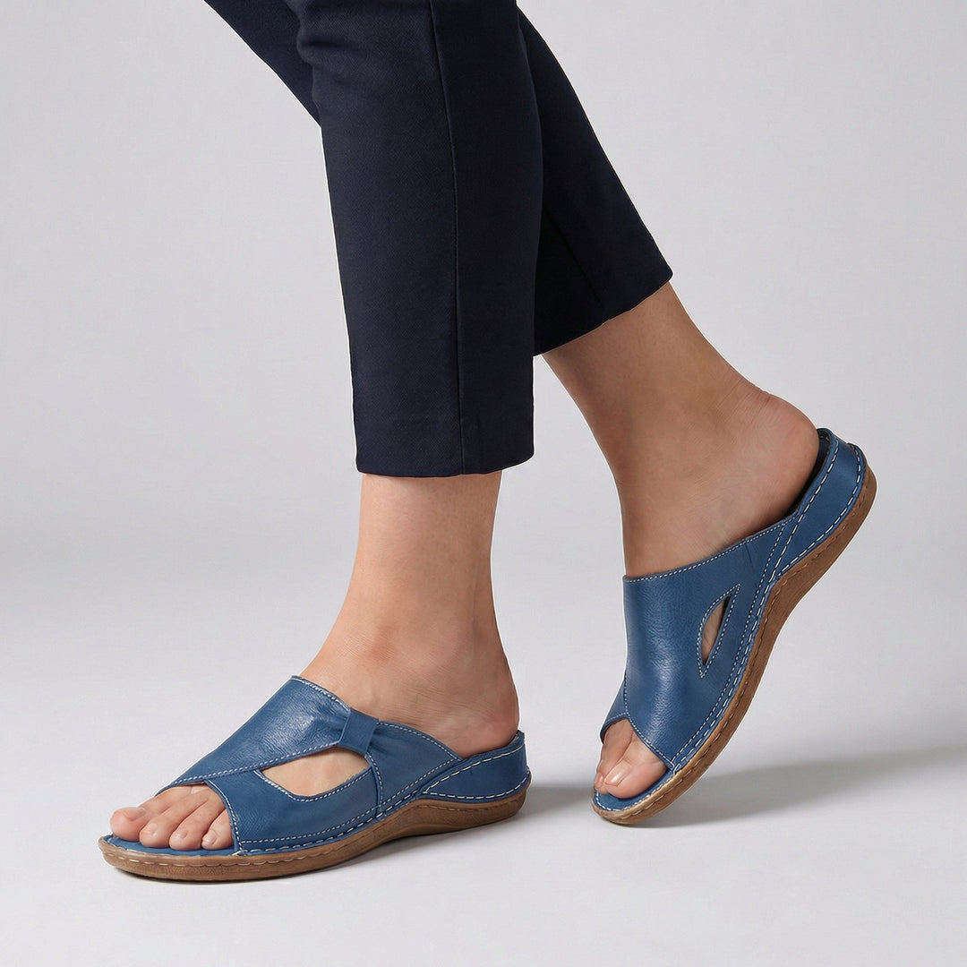 Close-up view of open-toe slide sandals with moulded footbed and arch support design