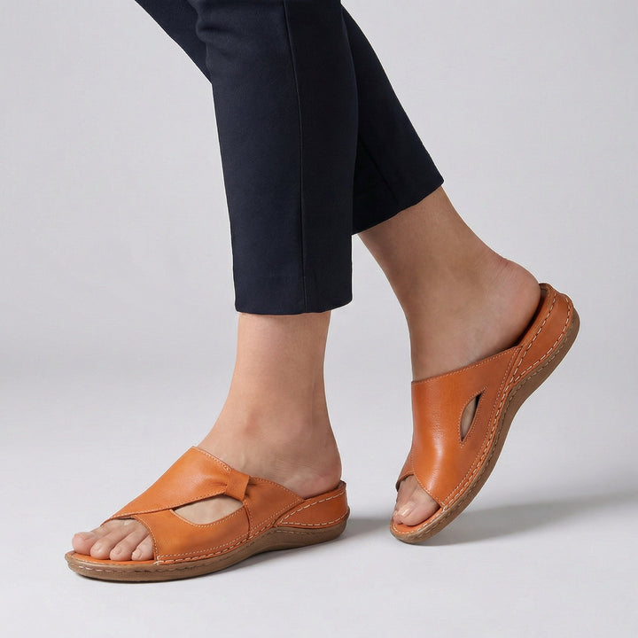 Detail shot of orthopedic slide sandals featuring cutout accents and cushioned insole for all-day comfort
