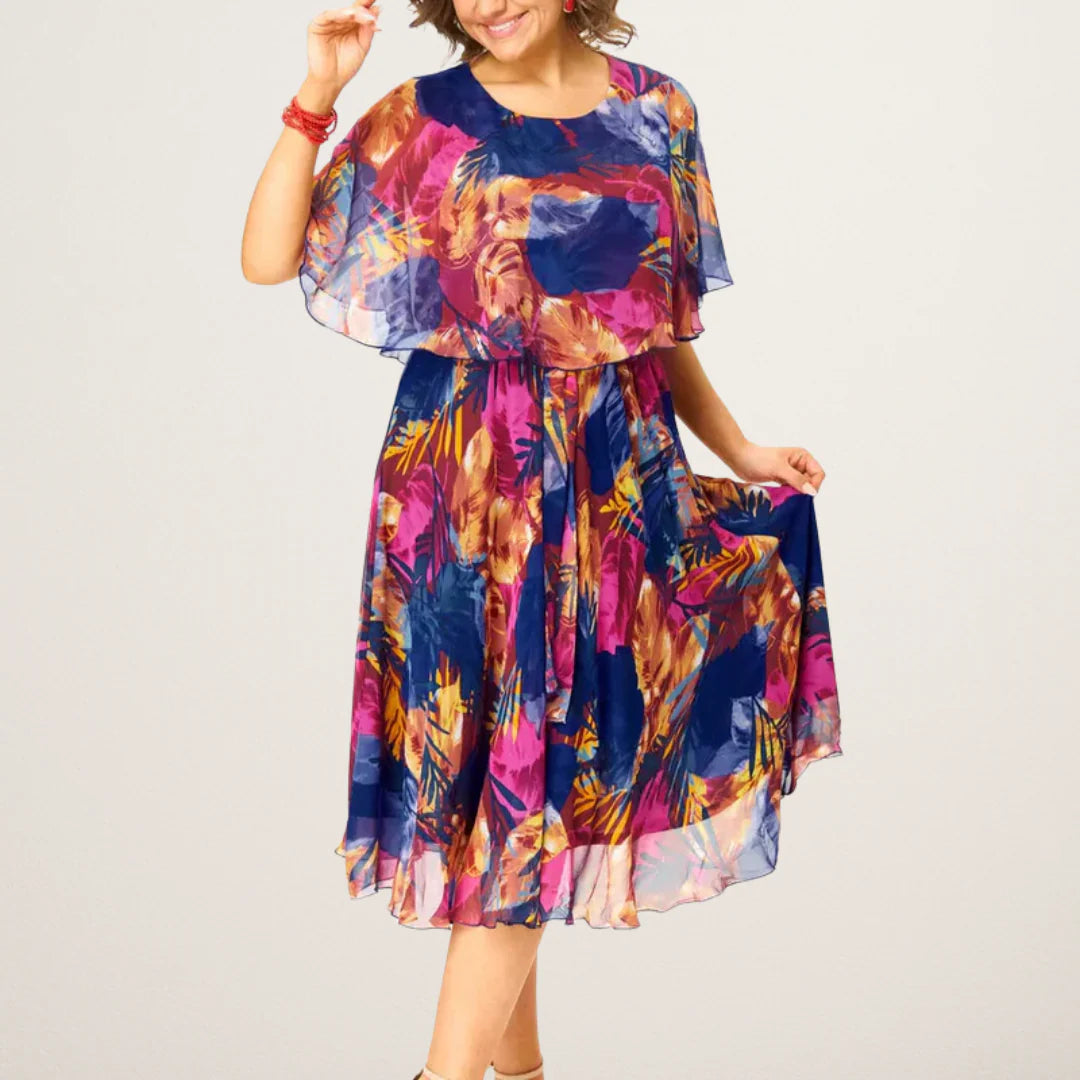 Tilly plus size chiffon dress floral with vibrant navy and magenta print, cape overlay, and flowing midi silhouette for summer occasions