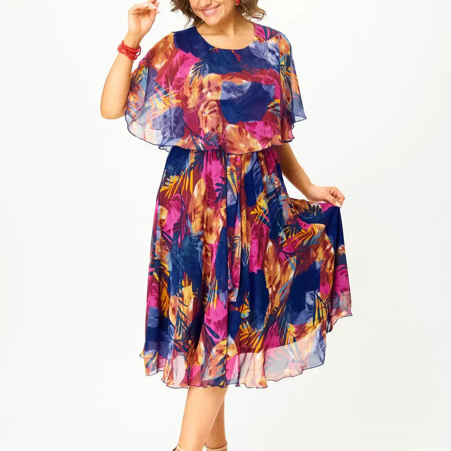 Close-up of floral chiffon dress showing bold print detail with navy, magenta, and orange tones across lightweight semi-sheer fabric