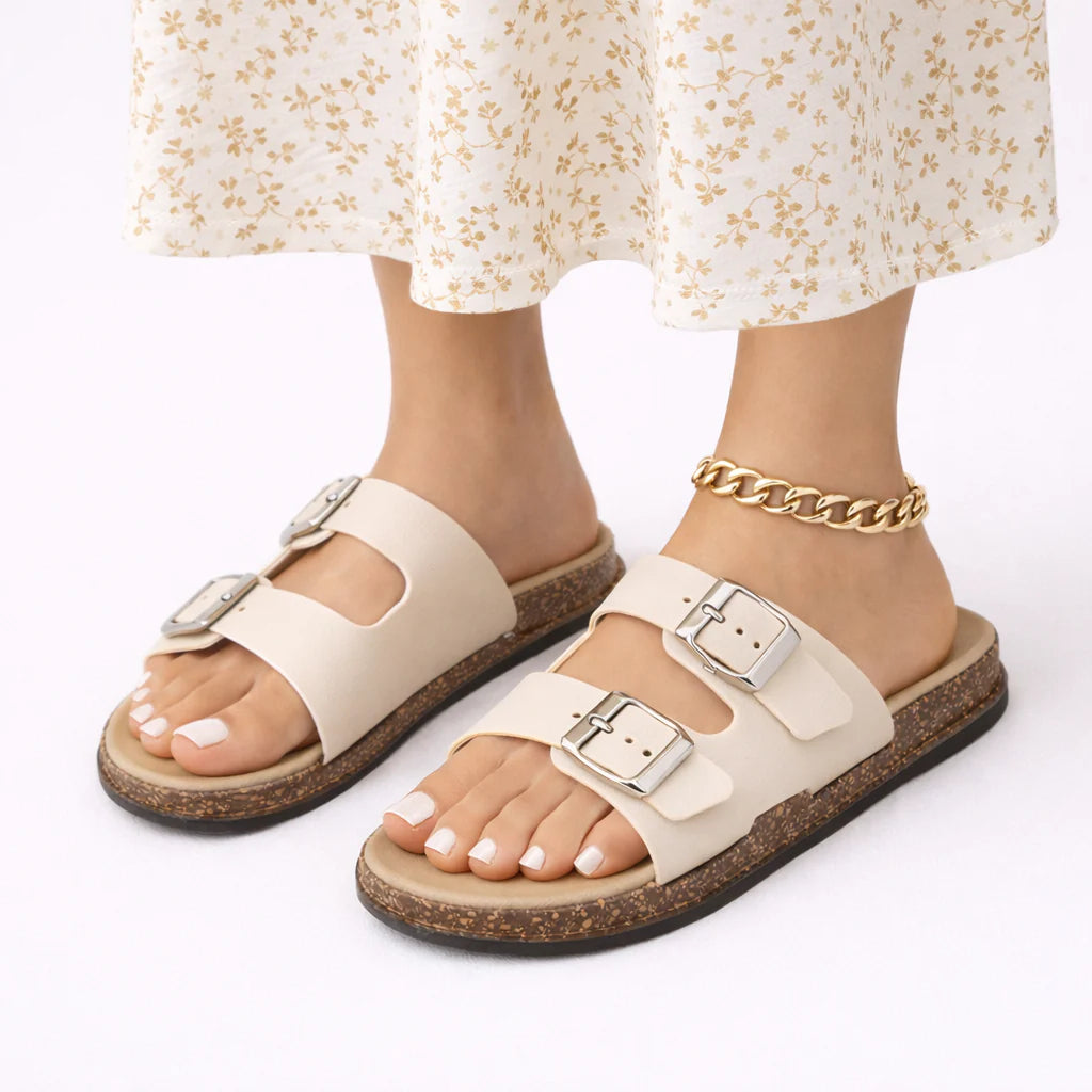 Tan buckle sandals with contoured footbed and cork sole styled for everyday summer wear