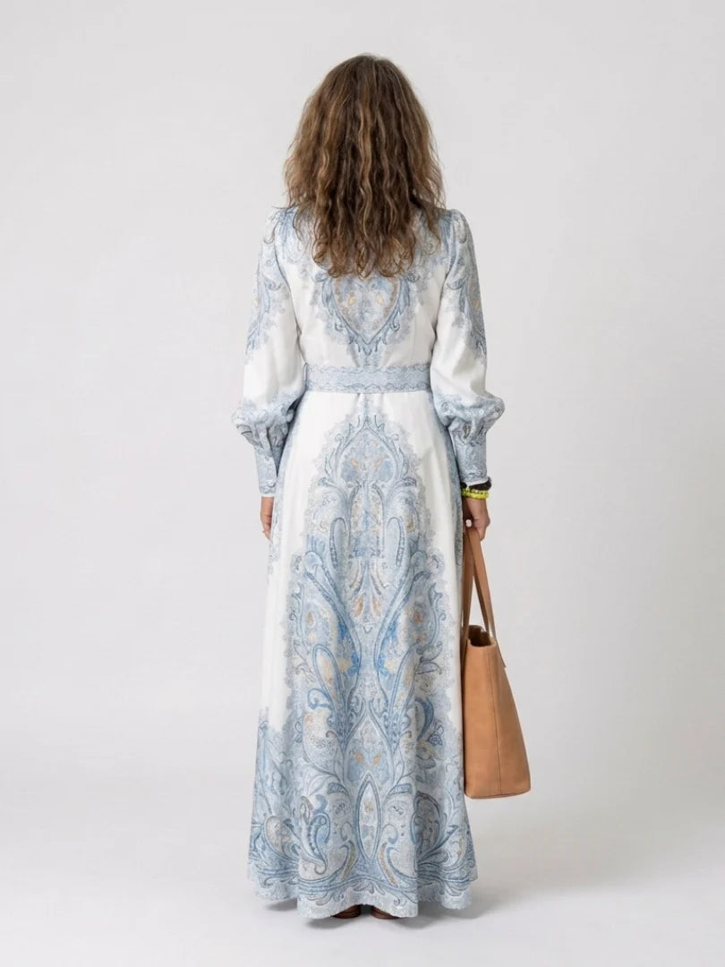 Detail of high neck collar and long sleeves with gathered cuffs on printed maxi dress