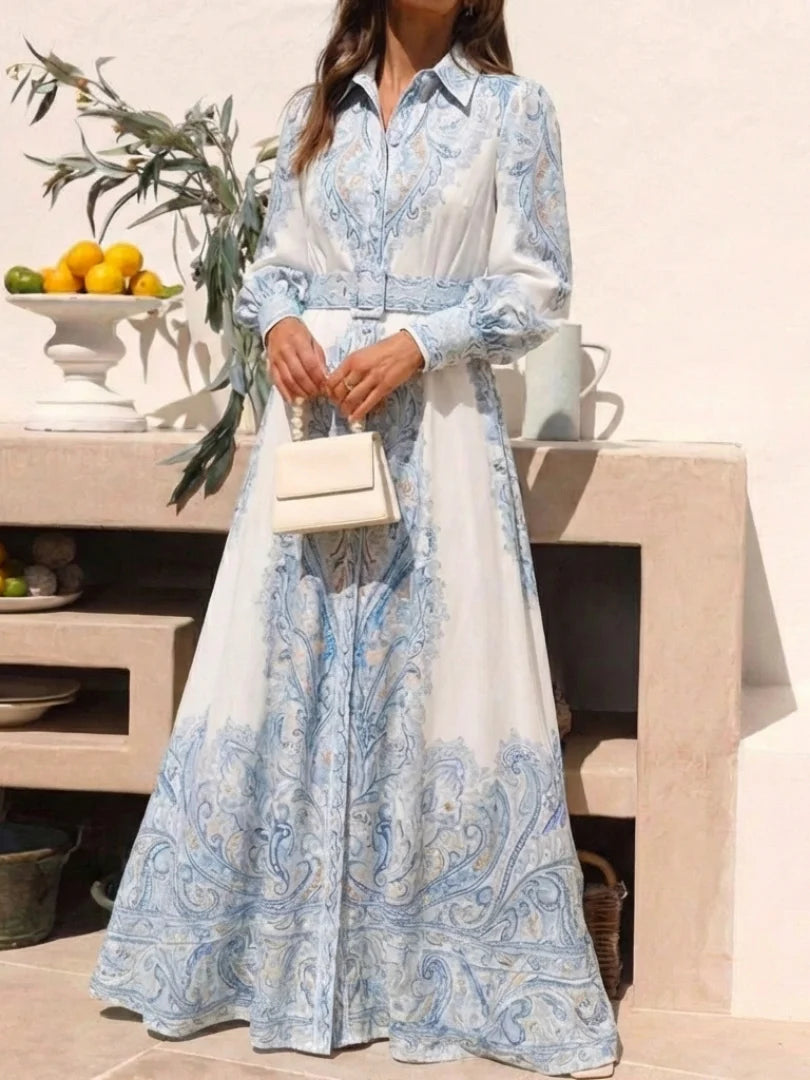 Close-up of intricate blue paisley print and smooth fabric on high neck maxi dress