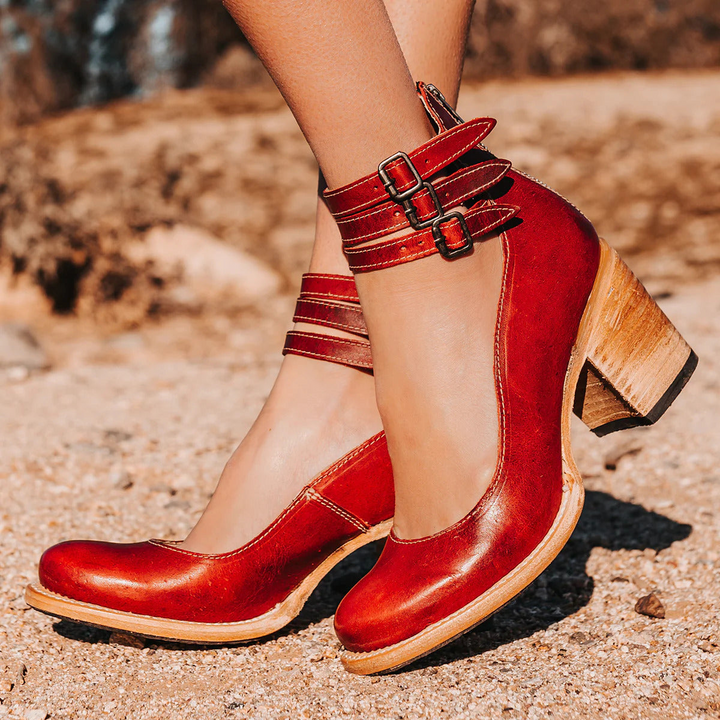Woman wearing red strappy ankle strap heels with tailored trousers for polished outfit