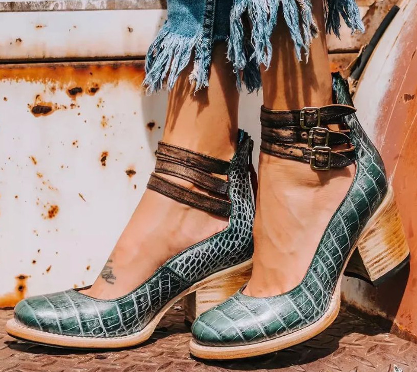 Woman styling dark brown block heel ankle boots with casual outfit for everyday wear
