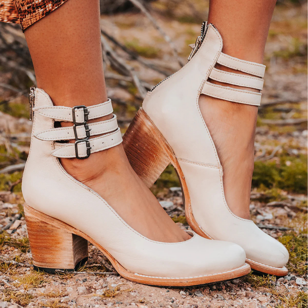 Close-up of double buckle ankle straps on brown block heel boots with stacked heel detail