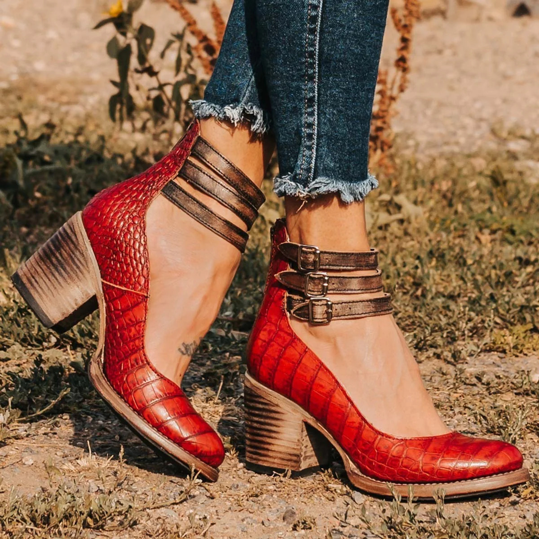 Woman wearing block heel ankle boots with flowing dress for casual outdoor occasion